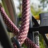 D-lock Bügelschloss sichert Sattelstange und Sattelstrebe mit Textilseil in Farbe chateau red am Fahrradständer
