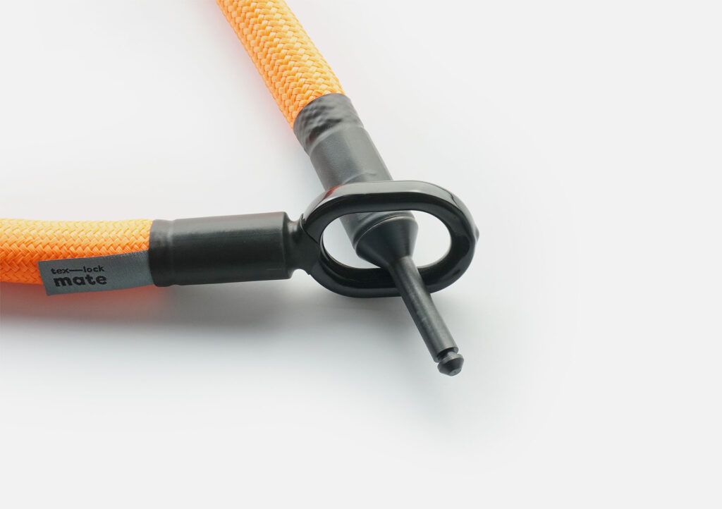 Locking bolt of the tex–lock mate  in acid orange through metal eyelet
