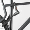 Hinterrad und Oberrohr vom Fahrrad mit schwarzem Seilschloss aus Textil an Fahrradständer angeschlossen