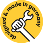 Rundes gelbes Logo mit Schriftzug designed and made in Germany mit Arm und Werkzeug